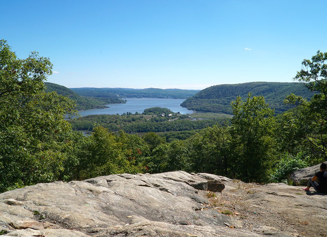 Contact - Aerial View From a Cliff Overlooking a Valley With a Large River on a Sunny Day