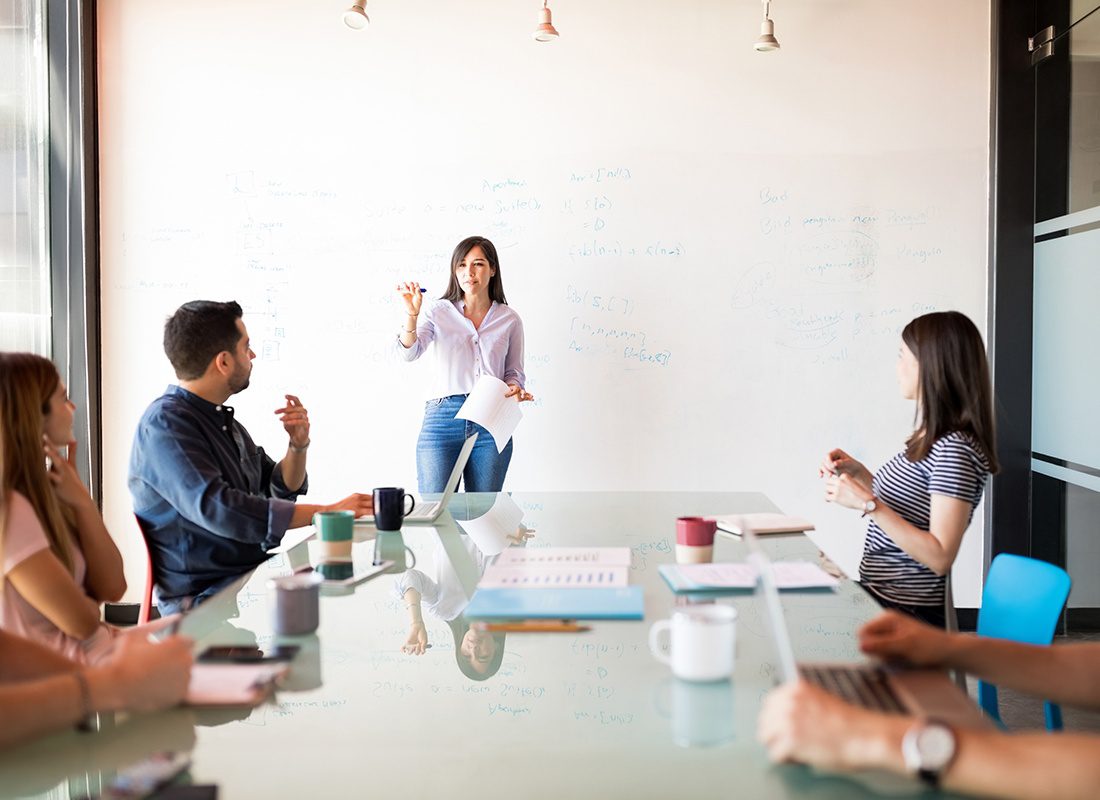 Insurance Solutions - Female Speaker Leads an Office Meeting